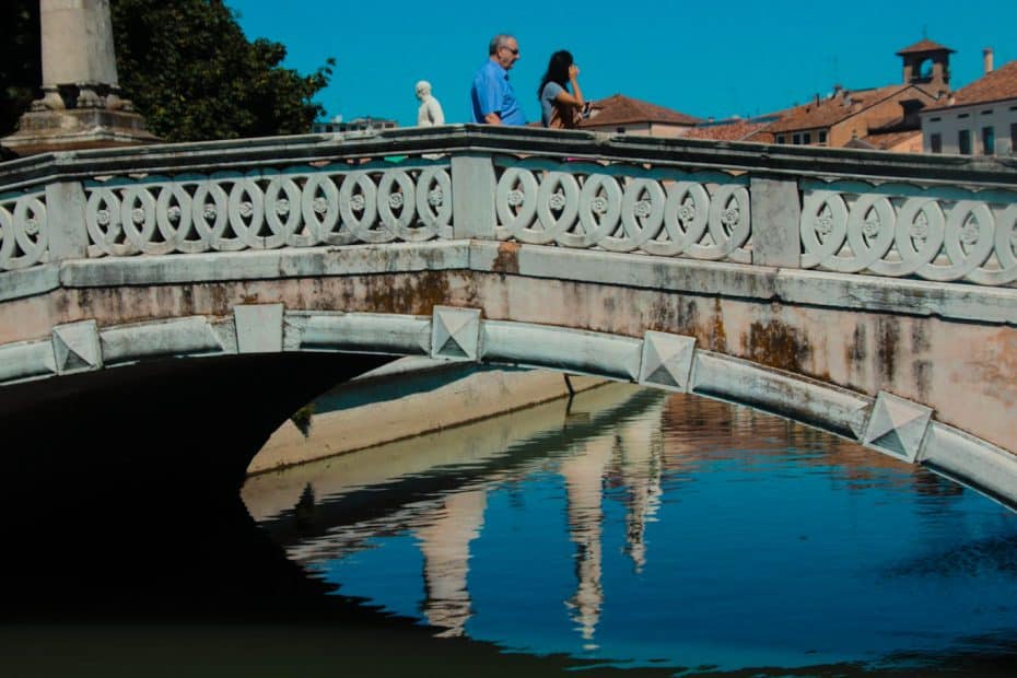 The statues in Prato della Valle are placed on stone pedestals surrounded by small bridges across the canal