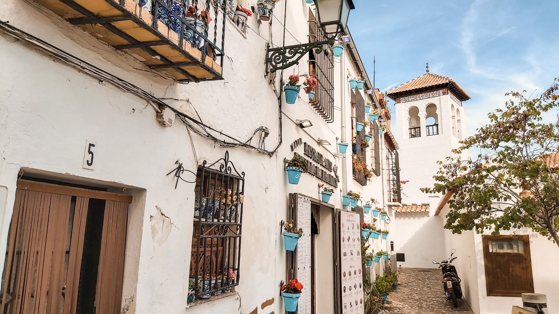 Albaicín is known for its narrow winding streets, whitewashed houses, and views of the Alhambra complex.
